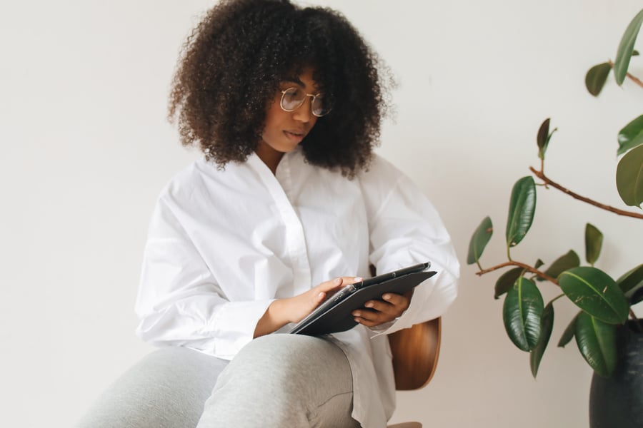 A Woman in a Dress Shirt Using a Tablet