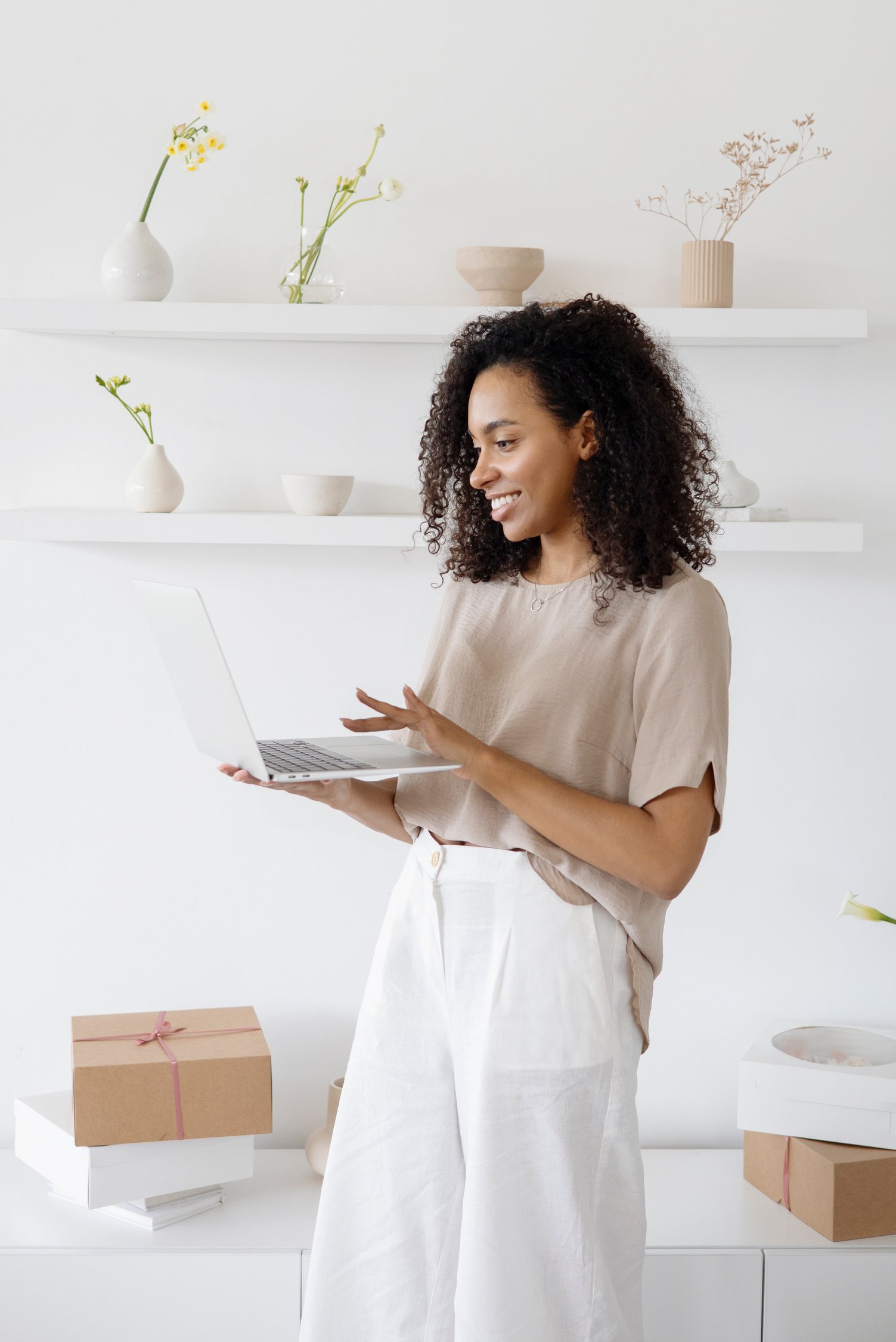 Woman Standing and Holding White Laptop